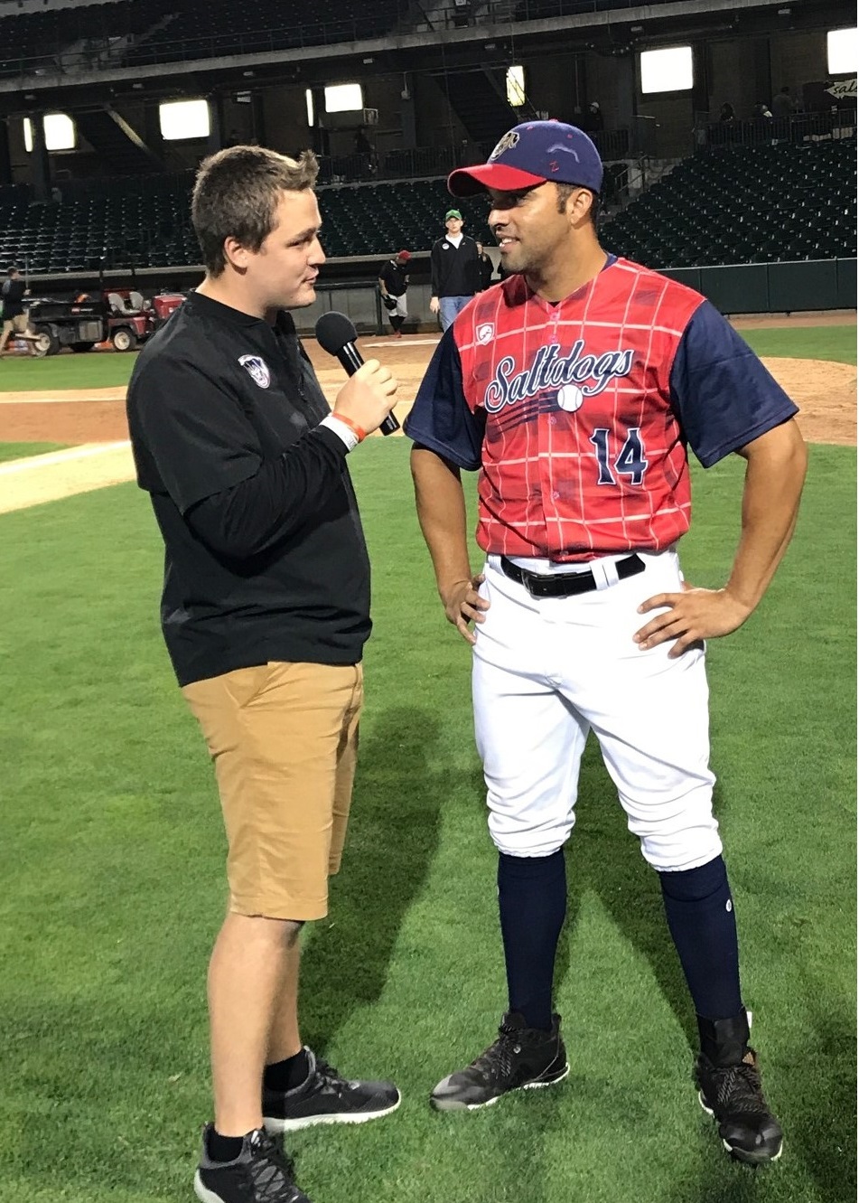   Ryan Schreurs (left) interviews Randolph Oduber, a Salt Dogs baseball player, during Schreurs’ internship in summer 2018.
